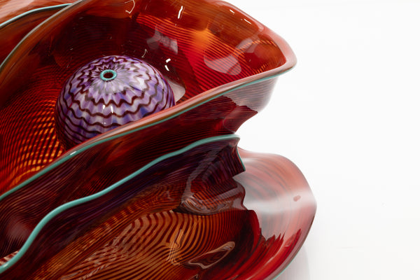 Dale Chihuly, Four Piece Red Seaform Set with Turquoise Lip Wrap, (1987) is a hand-blown glass sculpture featuring four organic red forms accented with a vibrant turquoise lip wrap