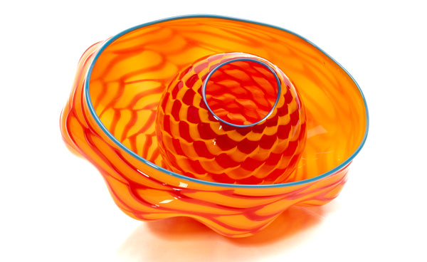 "Tiger Lily Seaform Pair", a unique hand-blown glass sculpture set by Dale Chihuly, features rich orange and red hues with a turquoise lip wrap