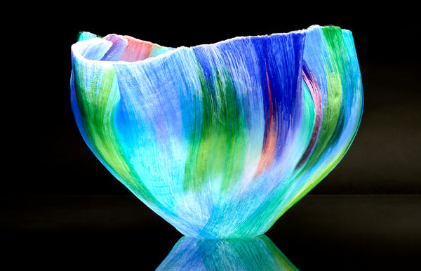 Mary Ann "Toots" Zynsky's *Untitled (Multicolor)* (c. 2000-2010) is a sculptural glass vessel featuring an undulating rim and vibrant bands of color that create depth and movement. Measuring 9.75" x 19" x 10", the work is signed "Z" on the underside.