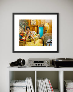 "Lovely Six Foota" by Mickalene Thomas is a limited-edition archival pigment print portraying a confident Black woman in harmonious unity with her environment